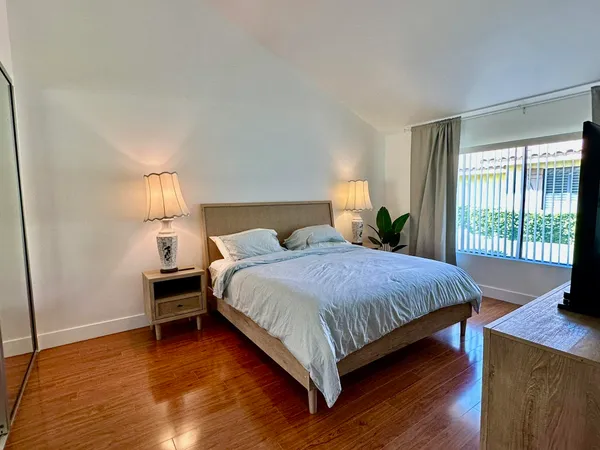 a bedroom with a bed and a window