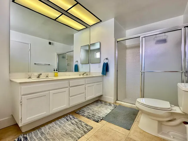 a spacious bathroom with a sink toilet and shower