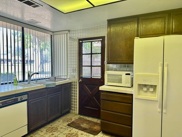 a kitchen with a refrigerator and a sink