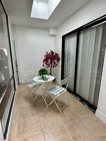 a view of a room with table and a potted plant