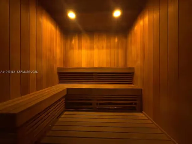 a view of room with stairs and wooden floor