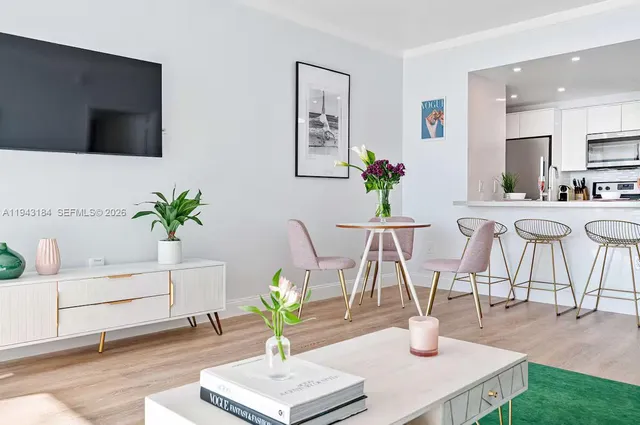 a dining room with furniture and a potted plant