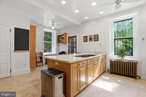 a kitchen that has a stove and a table in it
