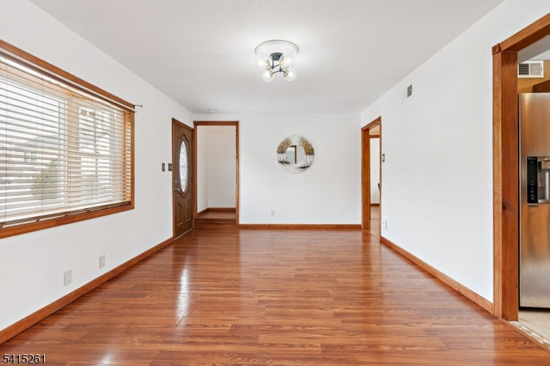 32 Glenville Road Edison, NJ 08817 - Photo 13 of 25 a view of an empty room with wooden floor and a window