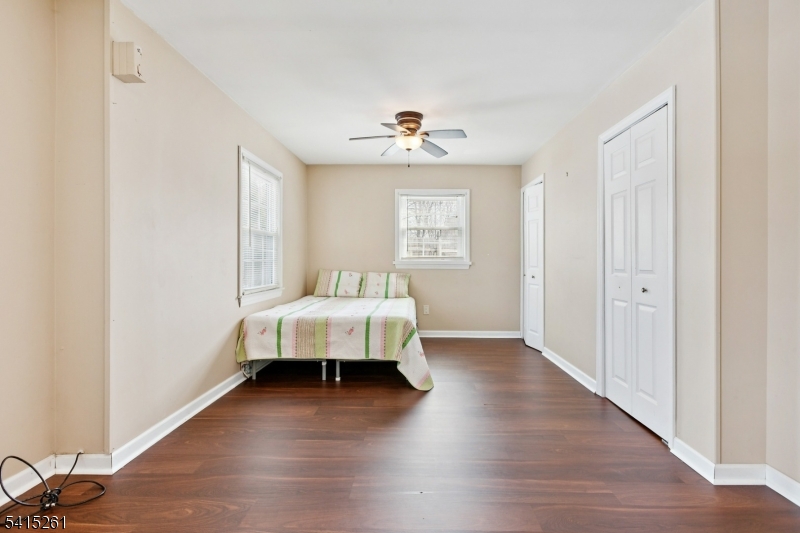 32 Glenville Road Edison, NJ 08817 - Photo 18 of 25 a bedroom with a bed and wooden floor