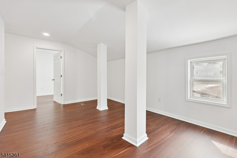 32 Glenville Road Edison, NJ 08817 - Photo 21 of 25 a view of an empty room with wooden floor and a window