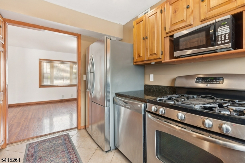 32 Glenville Road Edison, NJ 08817 - Photo 5 of 25 a kitchen with stainless steel appliances granite countertop a stove and a microwave