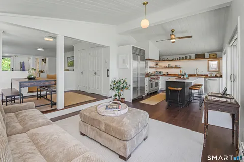 a kitchen with a table chairs and wooden cabinets