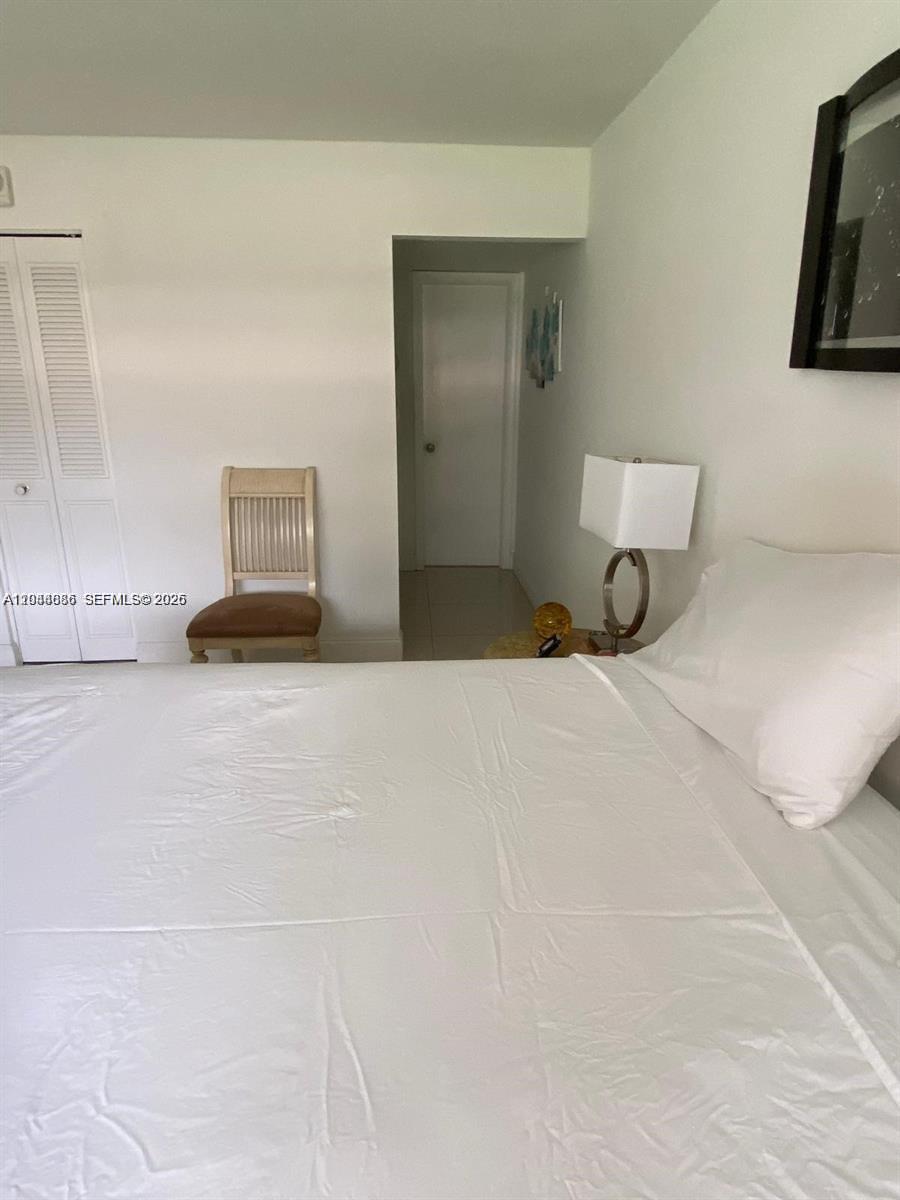 8838 West McNab Road, Unit 104 Tamarac, FL 33321 - Photo 10 of 23 a bedroom with a bed and night stand