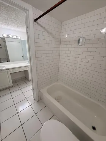 a bathroom with a bathtub and toilet
