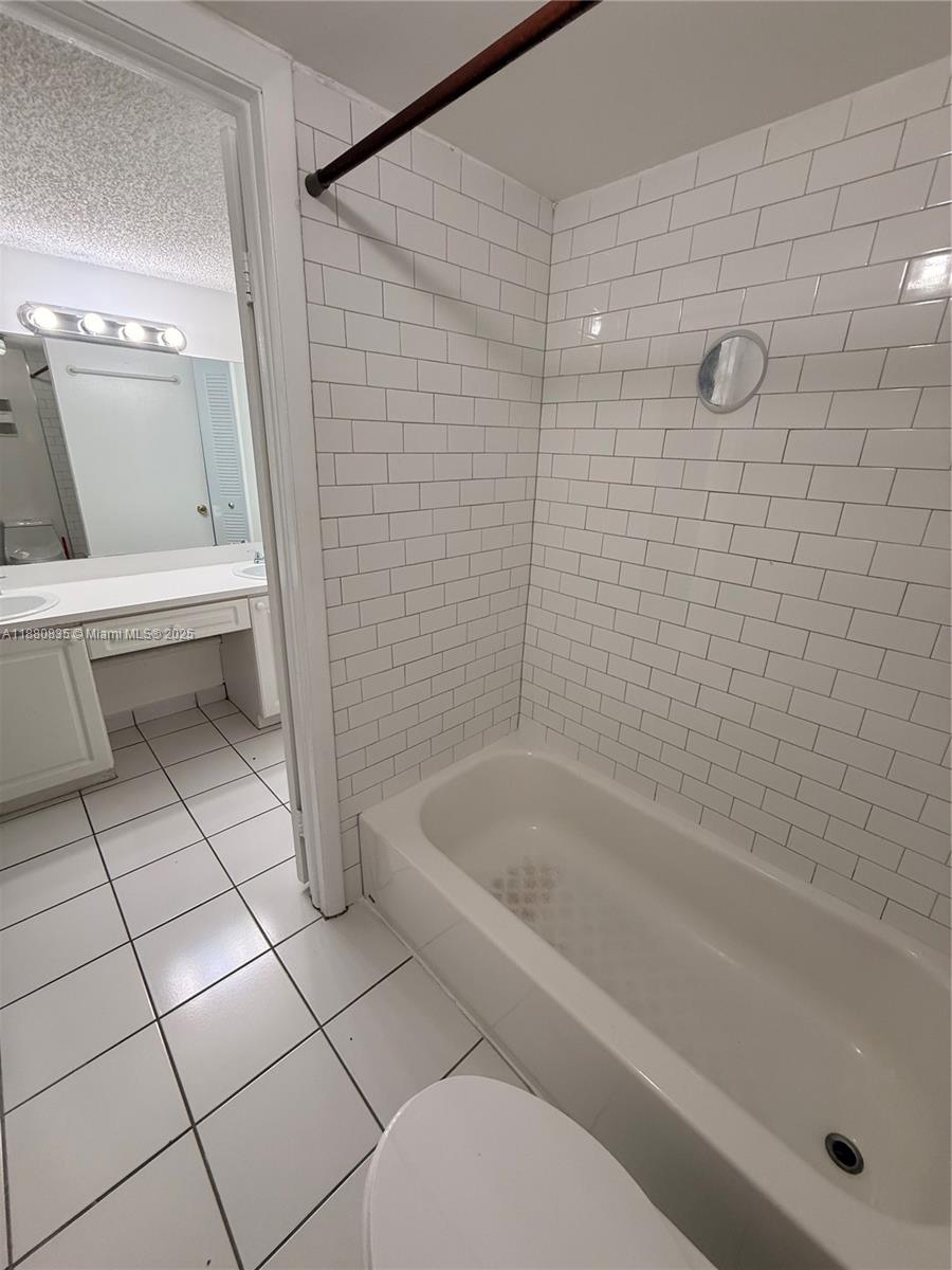 6300 Southwest 138th Court, Unit 102 Miami, FL 33183 - Photo 16 of 17 a bathroom with a bathtub and toilet