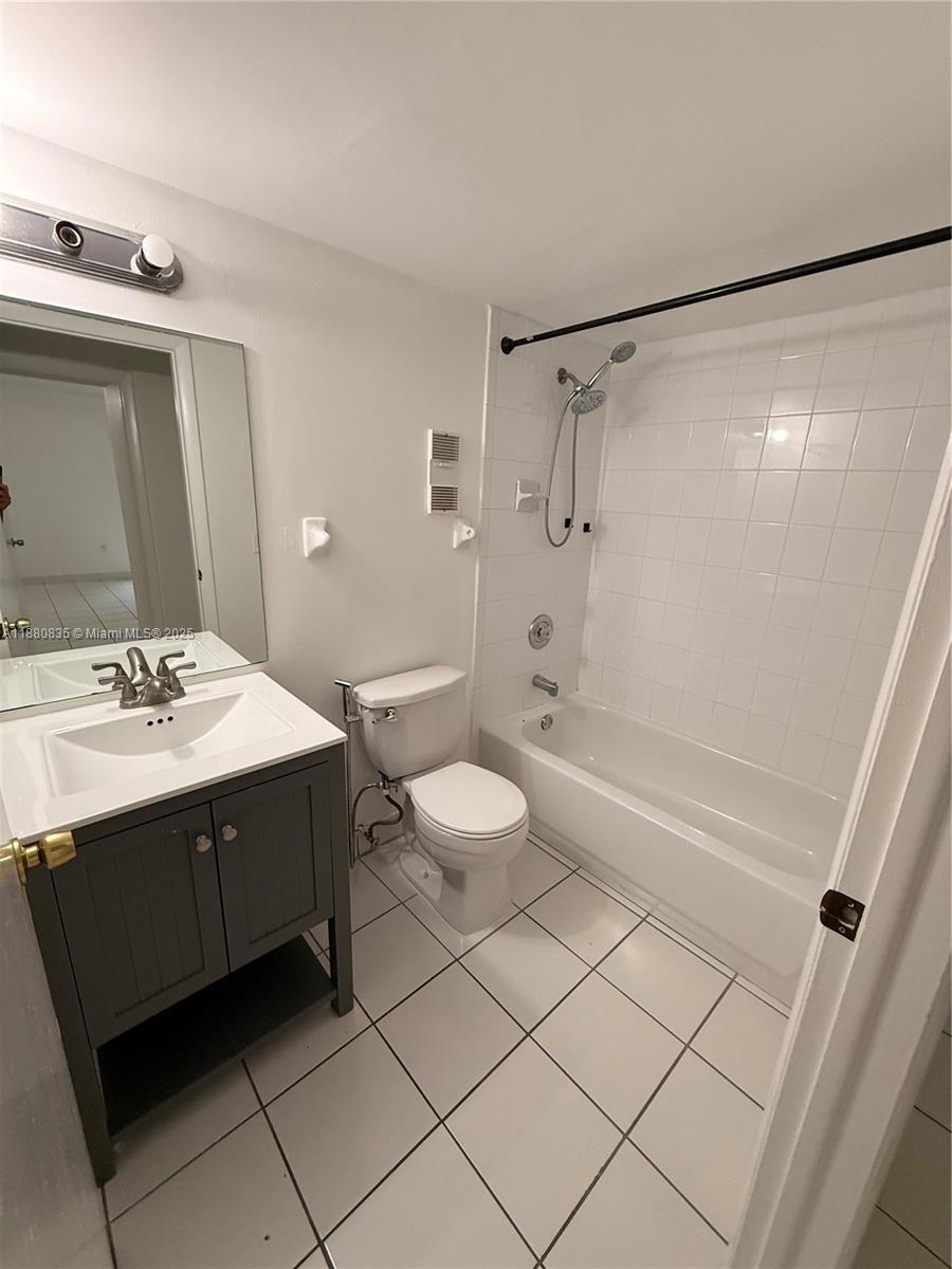 6300 Southwest 138th Court, Unit 102 Miami, FL 33183 - Photo 9 of 17 a bathroom with a sink and mirror with bathtub