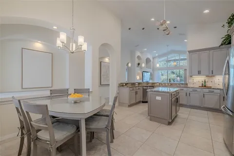 a view of a dining room with furniture and chandelier