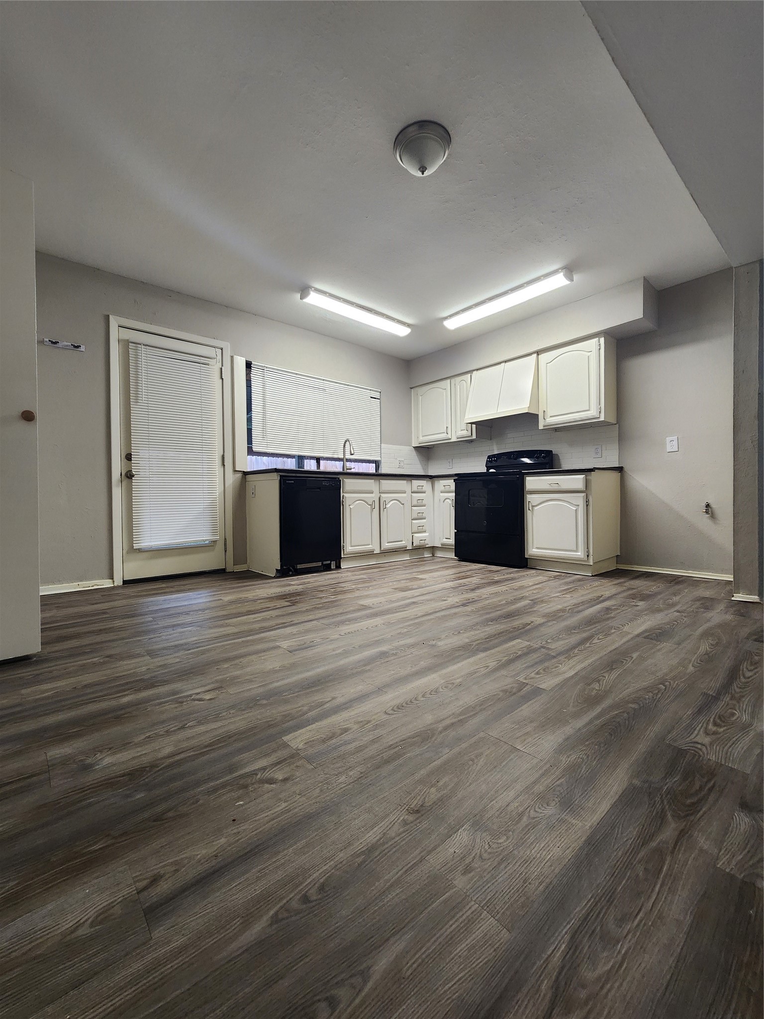 3822 Broken Elm Drive Spring, TX 77388 - Photo 24 of 25 a large kitchen with stainless steel appliances kitchen island granite countertop a large counter top and wooden floors