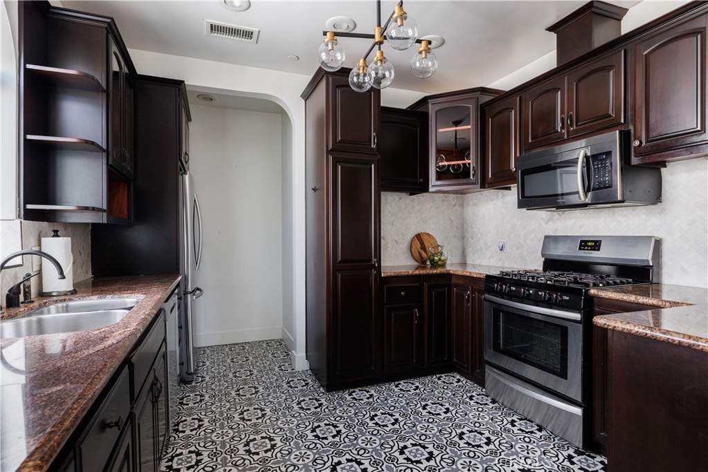 2820 Front Street Alhambra, CA 91803 - Photo 10 of 19 a kitchen with stainless steel appliances granite countertop a sink stove and refrigerator