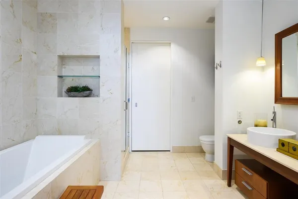 a bathroom with a bathtub sink and toilet