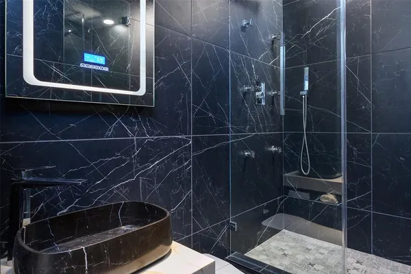 a bathroom with a shower and a sink