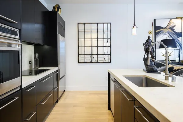 a kitchen with a sink and refrigerator