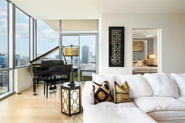 a living room with furniture and a piano