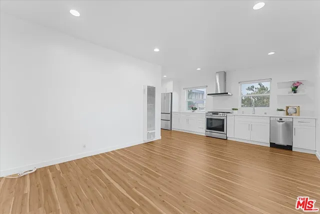 a view of kitchen with granite countertop cabinets and white appliances