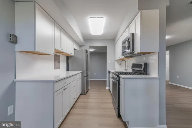 a kitchen with stainless steel appliances granite countertop a stove and a refrigerator