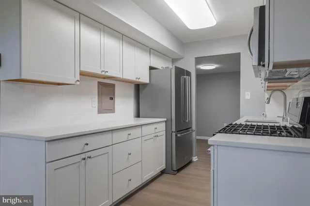 a kitchen with cabinets and window