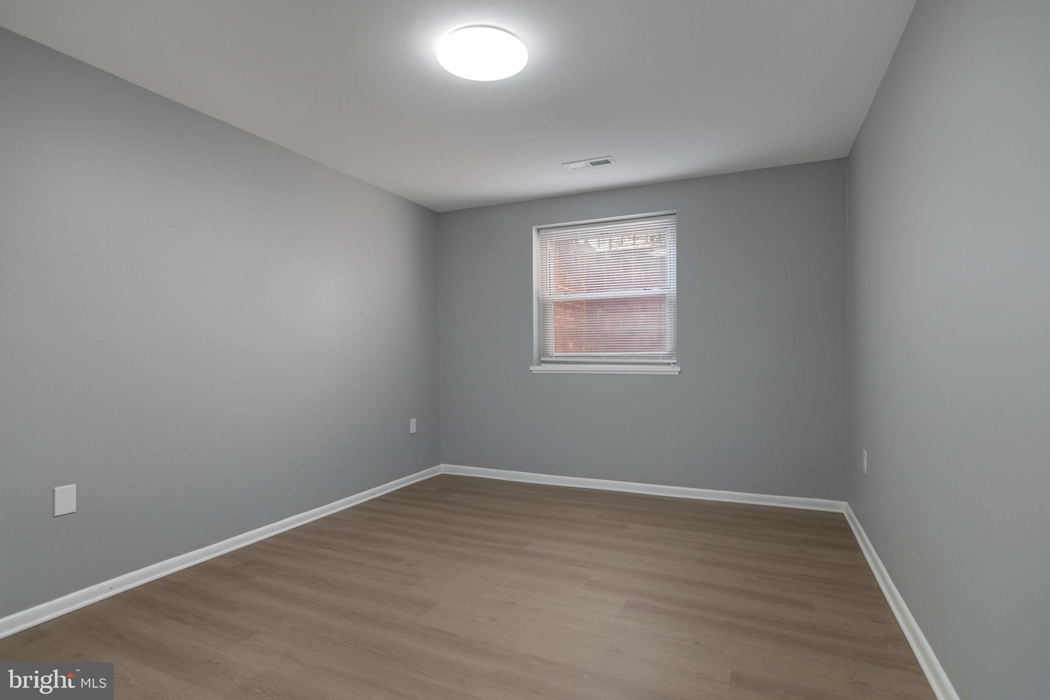 3356 Woodburn Road, Unit T3 Annandale, VA 22003 - Photo 15 of 35 an empty room with wooden floor and windows