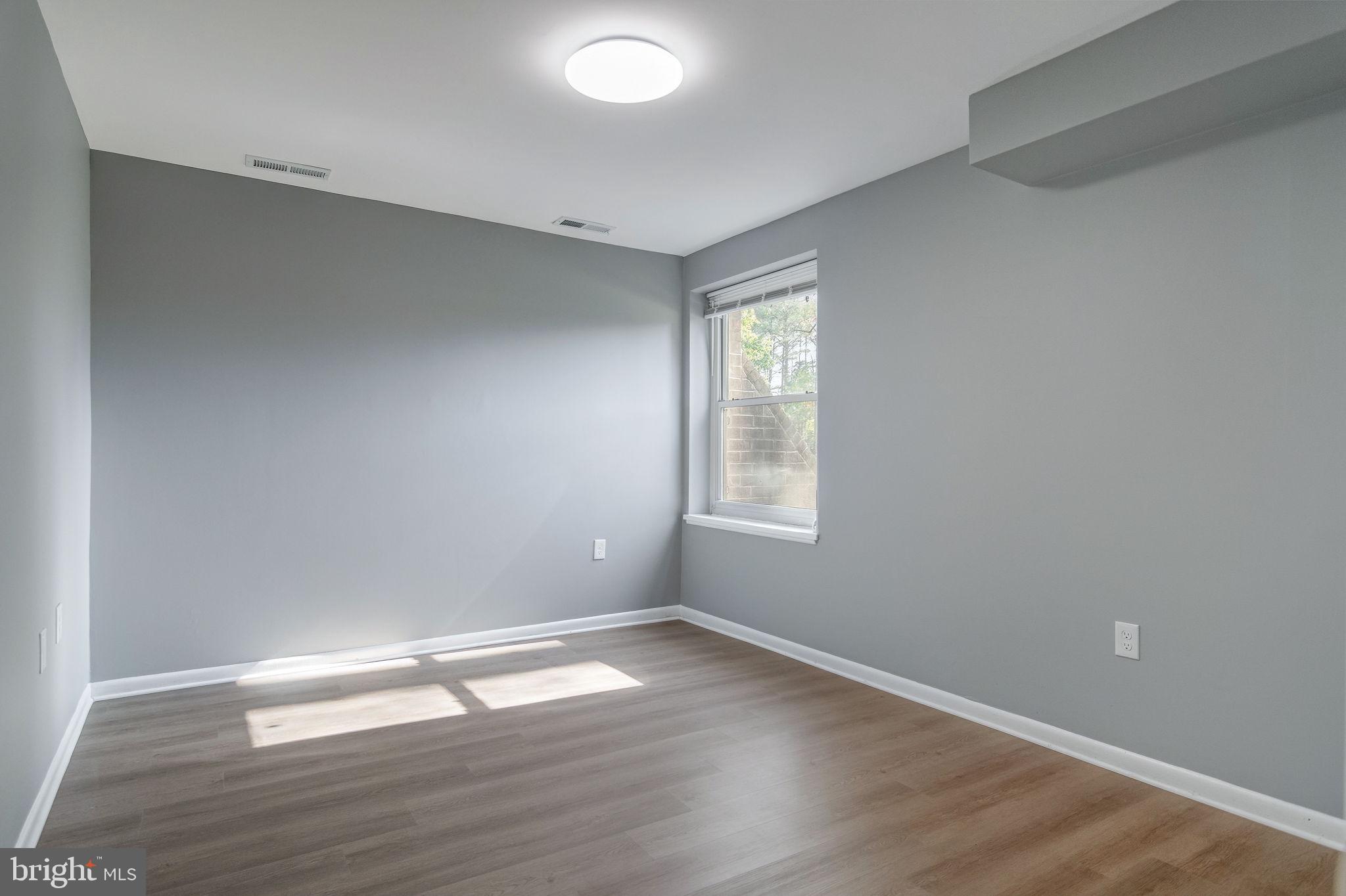 3356 Woodburn Road, Unit T3 Annandale, VA 22003 - Photo 23 of 35 an empty room with wooden floor and windows