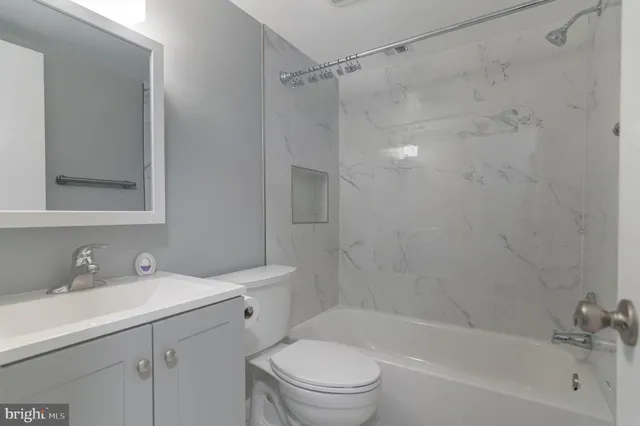 a bathroom with a sink mirror toilet and bathtub