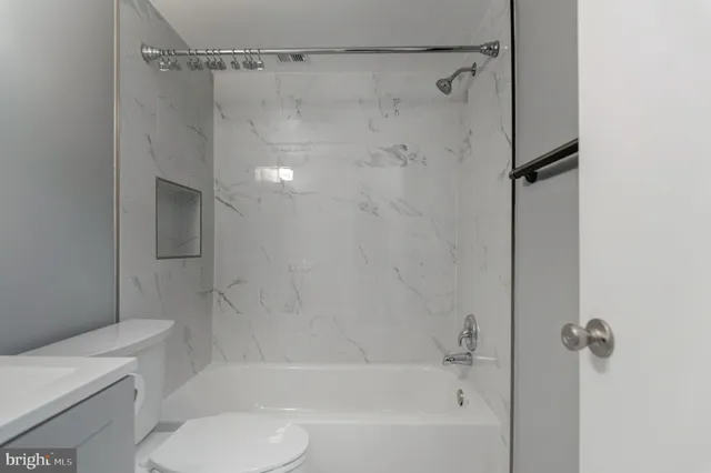 a bathroom with a shower and a toilet