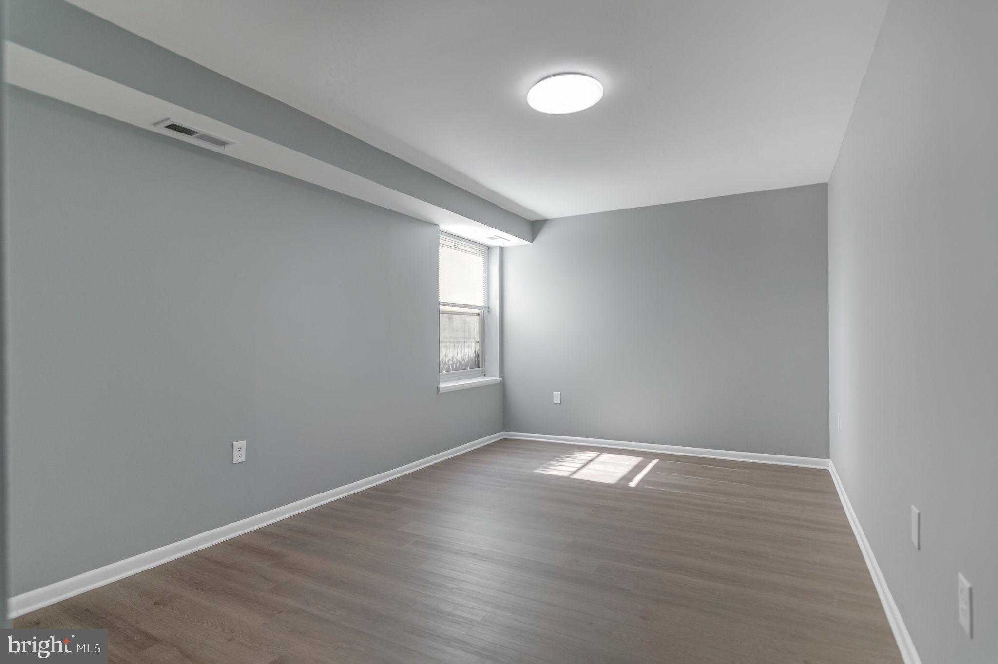 3356 Woodburn Road, Unit T3 Annandale, VA 22003 - Photo 28 of 35 an empty room with wooden floor and windows