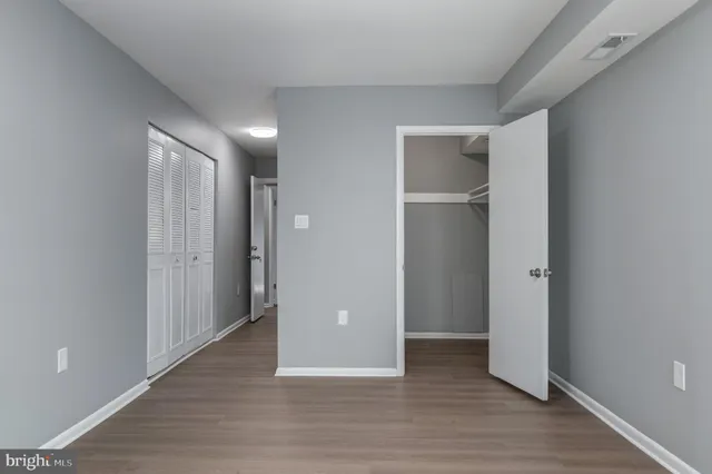 a view of an empty room with wooden floor