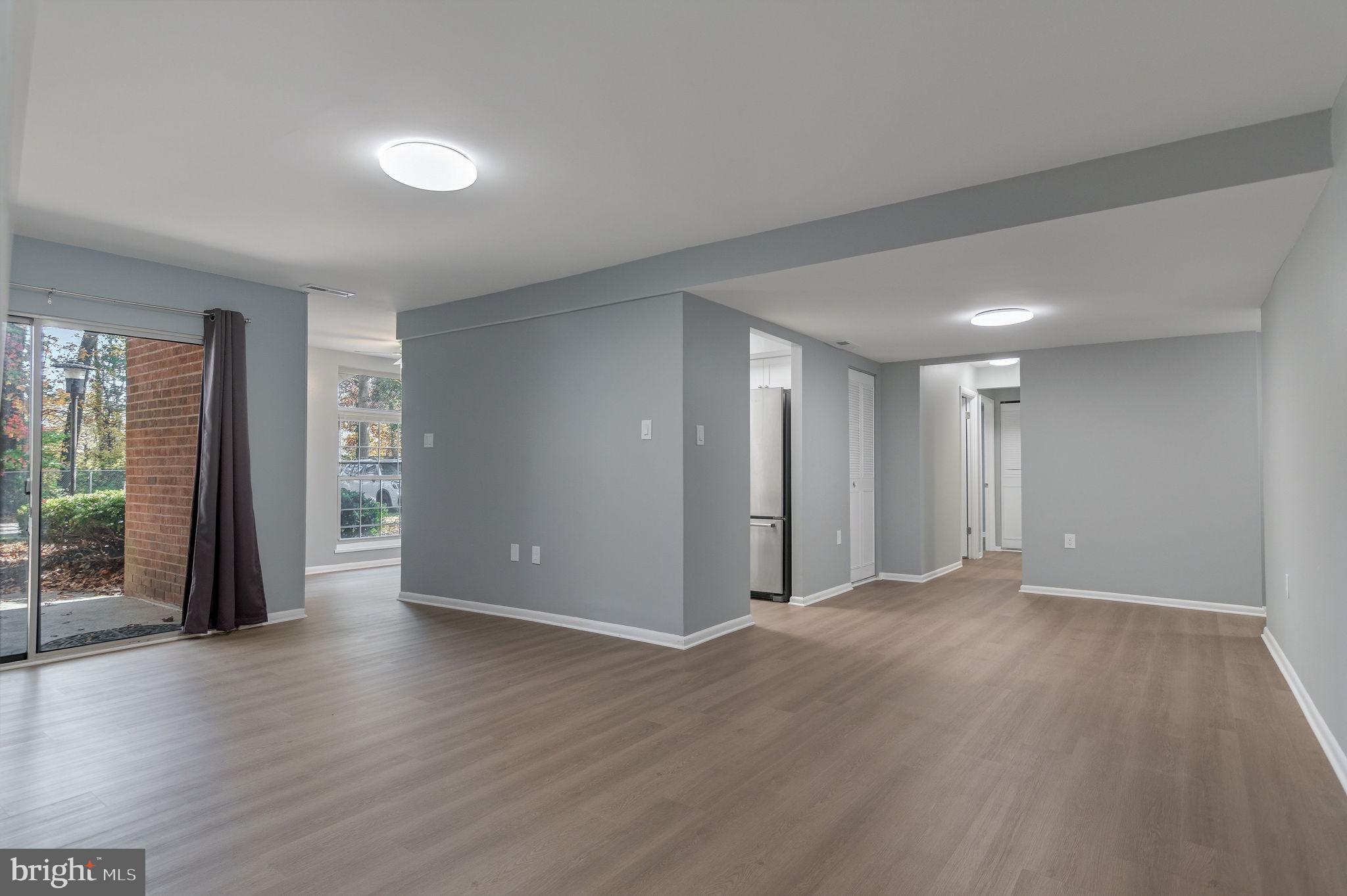3356 Woodburn Road, Unit T3 Annandale, VA 22003 - Photo 3 of 35 a view of an empty room with wooden floor and a window