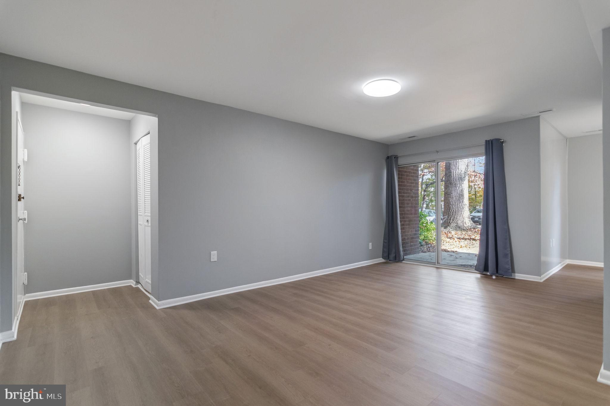 3356 Woodburn Road, Unit T3 Annandale, VA 22003 - Photo 4 of 35 a view of an empty room with wooden floor and a window