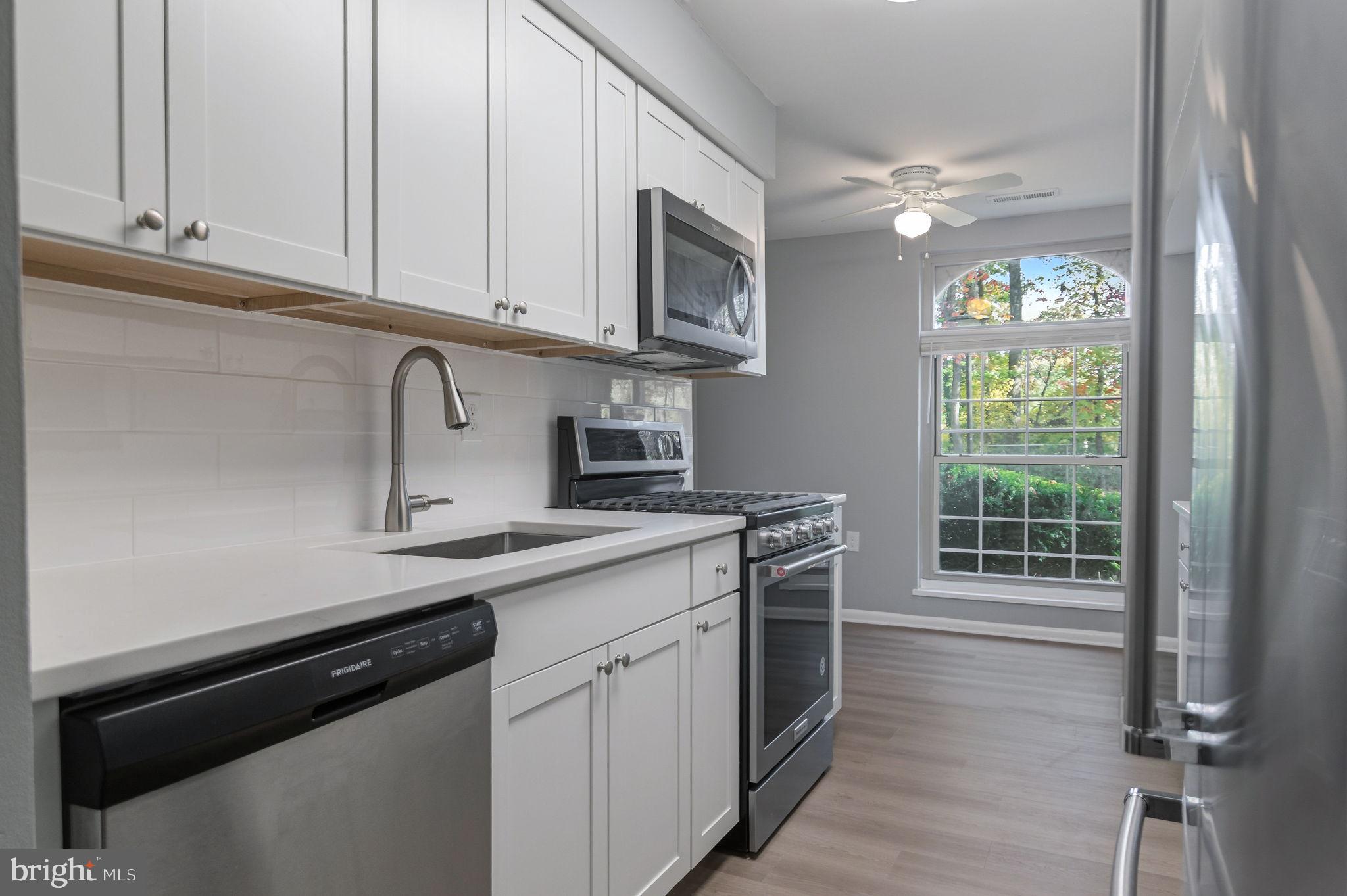 3356 Woodburn Road, Unit T3 Annandale, VA 22003 - Photo 8 of 35 a kitchen with stainless steel appliances granite countertop a sink a stove a microwave and cabinets
