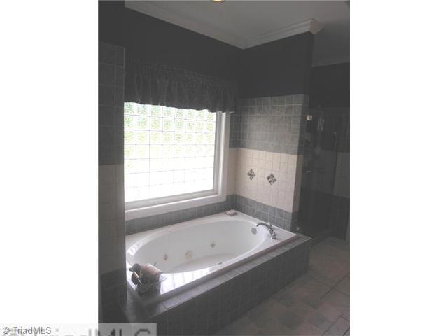 1161 Gravel Hill Road Ruffin, NC 27326 - Photo 13 of 16 Master Bath/Spa. Master bath features Jacuzzi tub, separate glass shower and ENORMOUS closet with natural light