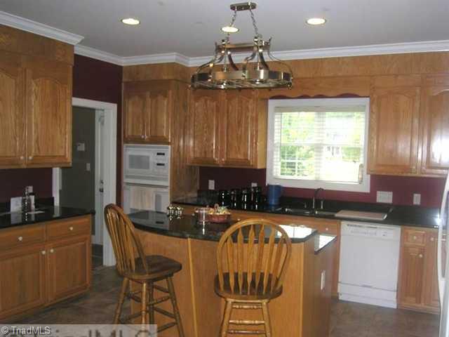 1161 Gravel Hill Road Ruffin, NC 27326 - Photo 7 of 16 Kitchen. Kitchen with granite, recessed lighting and oak cabinetry