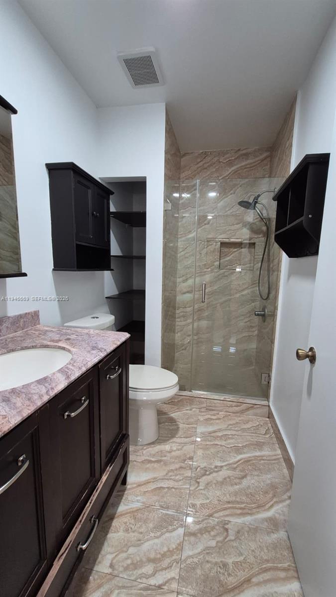 8531 Southwest 109th Avenue Miami, FL 33173 - Photo 14 of 19 a bathroom with a granite countertop sink toilet and shower
