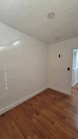 a view of room with wooden floor