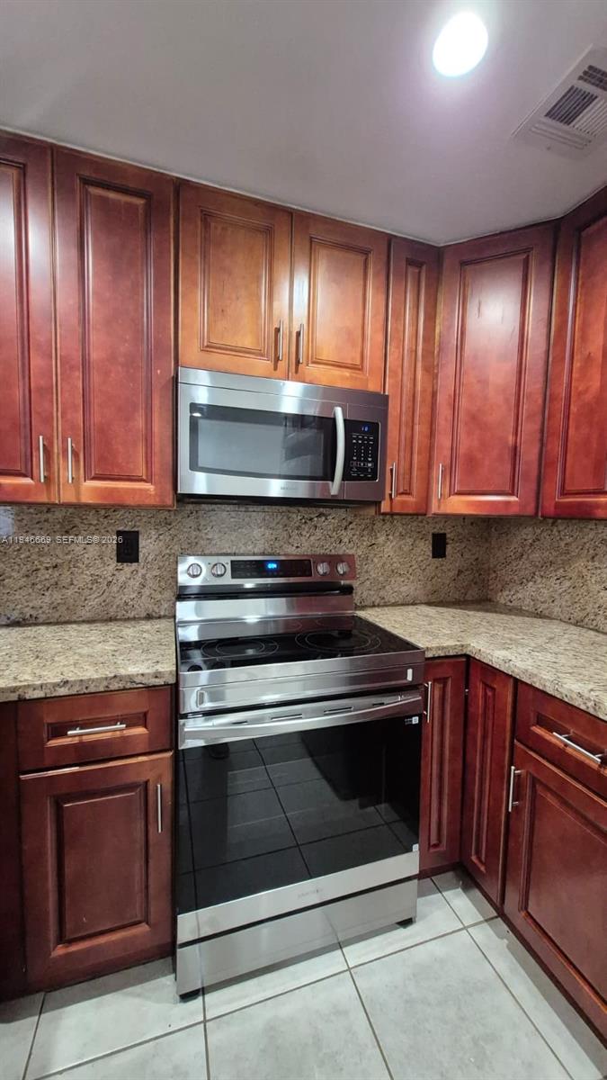 8531 Southwest 109th Avenue Miami, FL 33173 - Photo 3 of 19 a stove top oven sitting inside of a kitchen