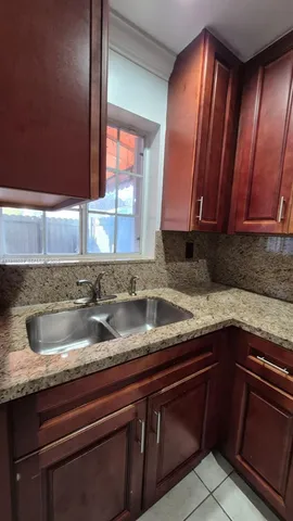 a kitchen with a sink and cabinets