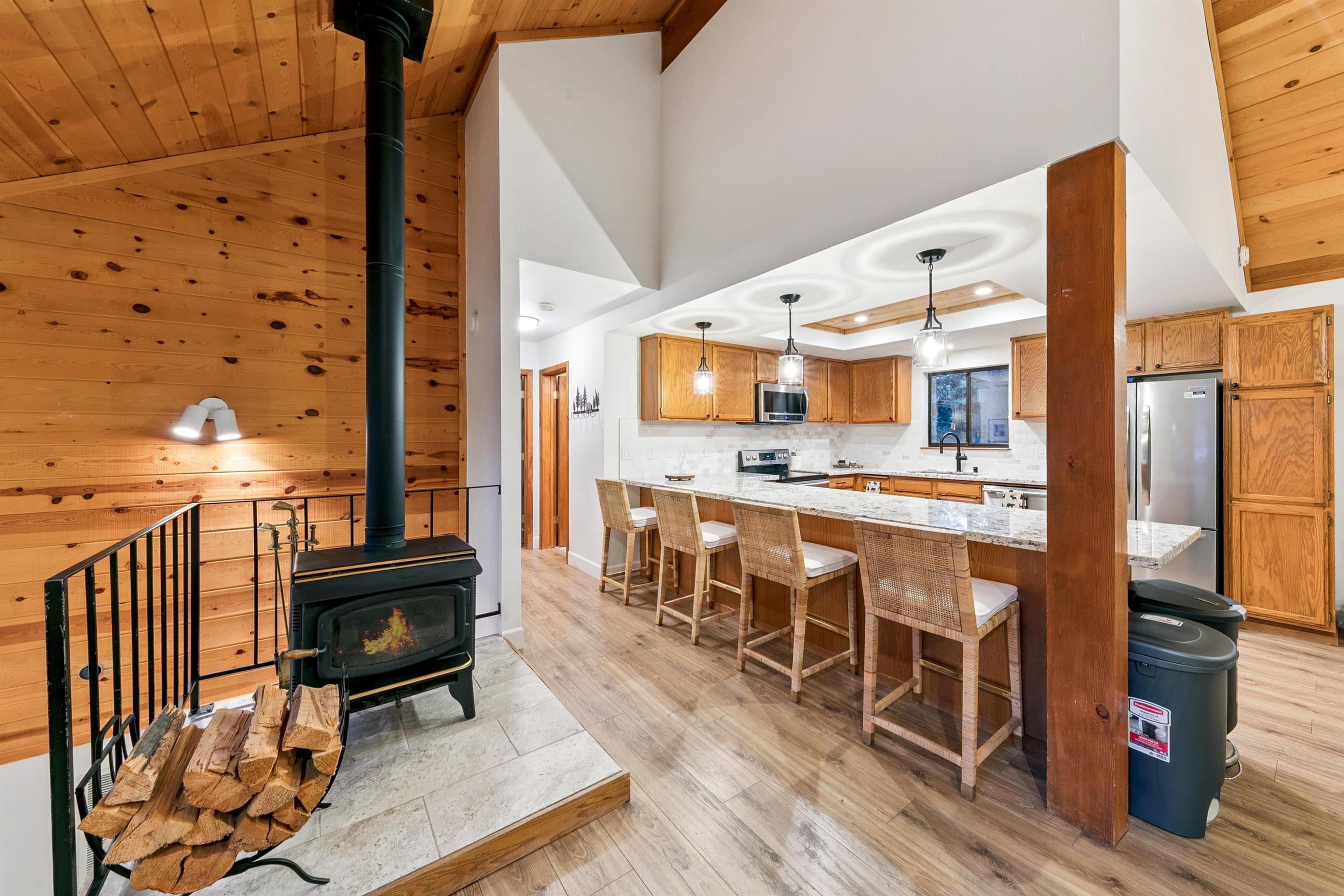 12095 Oslo Drive Truckee, CA 96161 - Photo 11 of 28 a living room with stainless steel appliances kitchen island granite countertop furniture and a fireplace