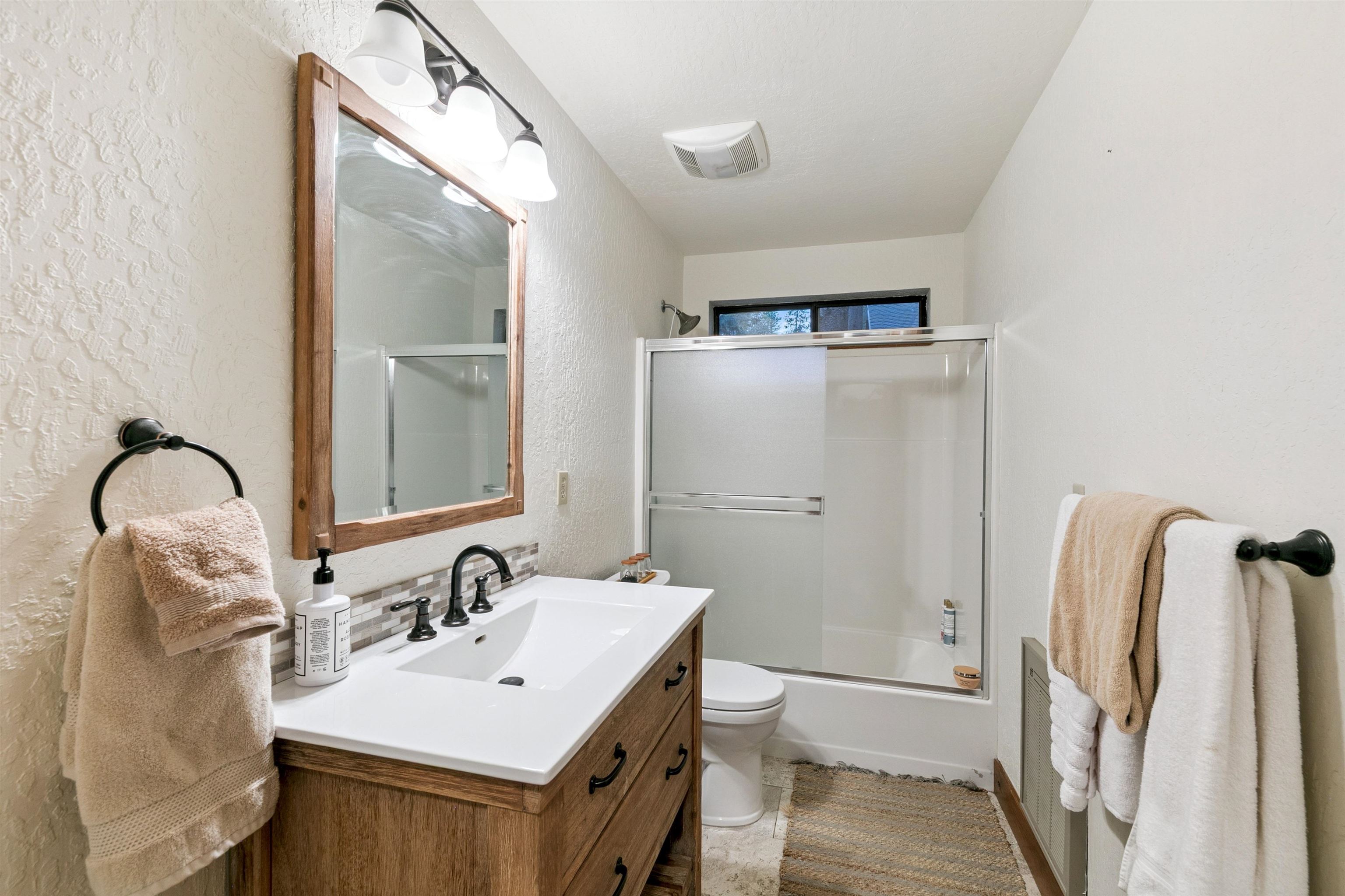 12095 Oslo Drive Truckee, CA 96161 - Photo 20 of 28 a bathroom with a sink mirror and shower
