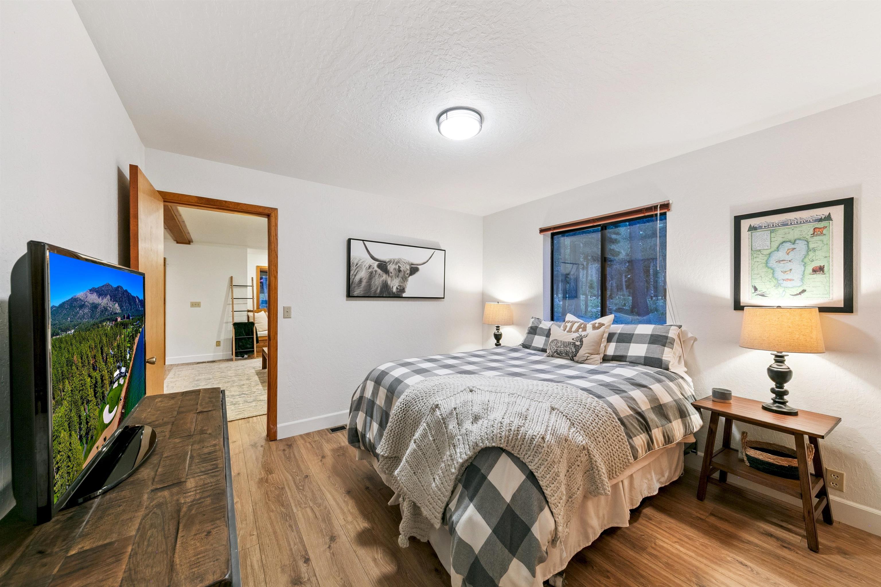 12095 Oslo Drive Truckee, CA 96161 - Photo 21 of 28 a bedroom with a bed and a flat screen tv