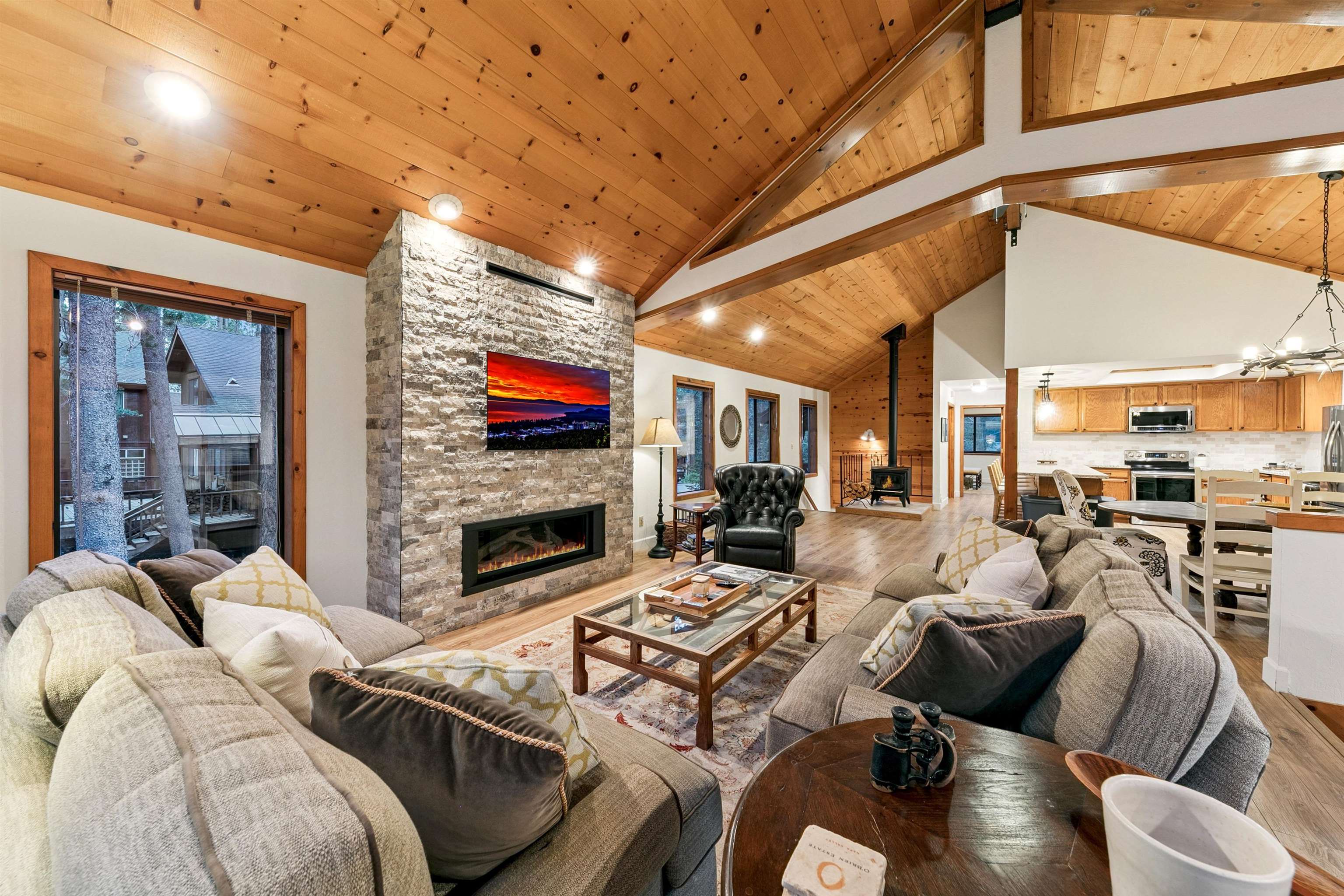 12095 Oslo Drive Truckee, CA 96161 - Photo 5 of 28 a living room with furniture a fireplace and a flat screen tv