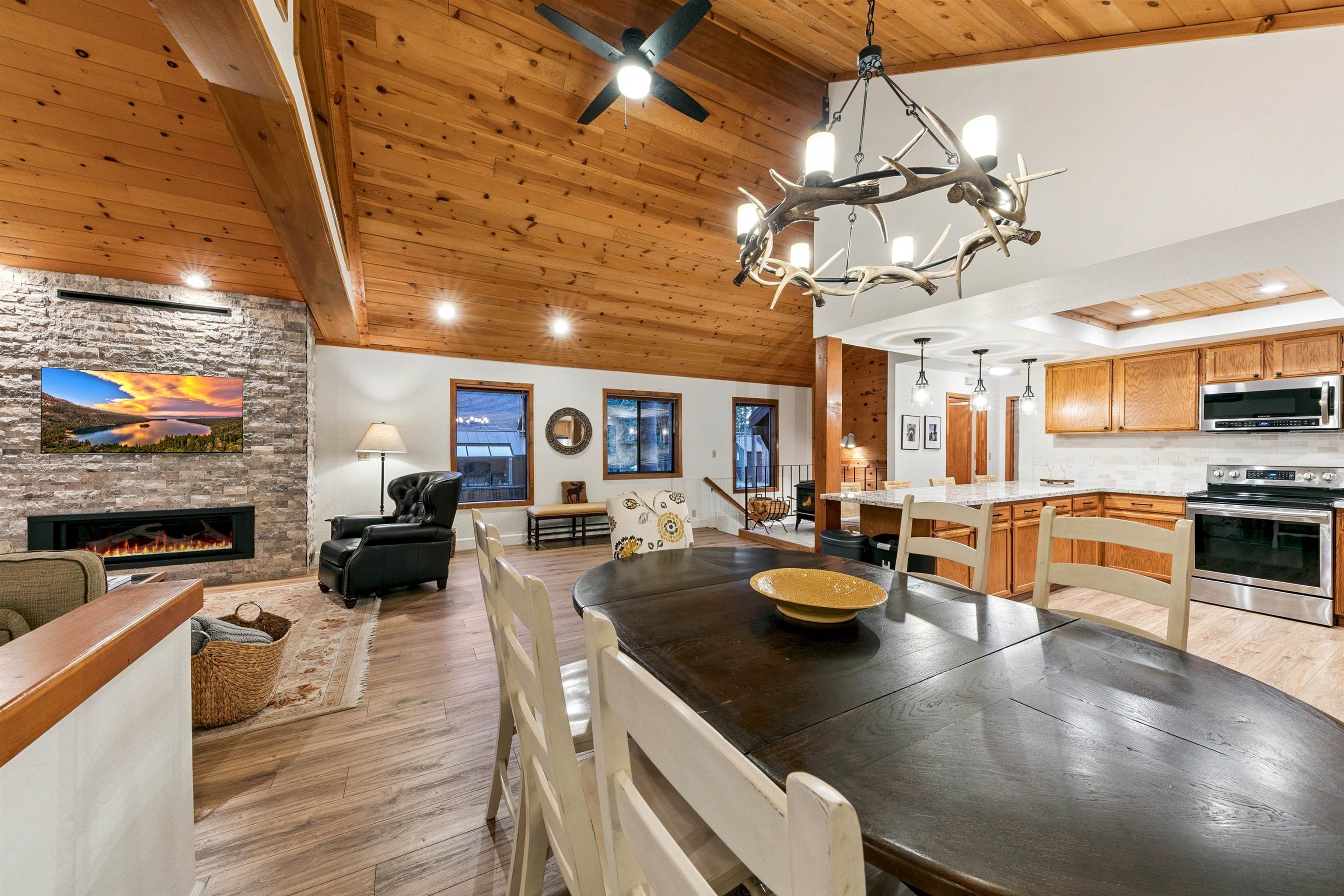 12095 Oslo Drive Truckee, CA 96161 - Photo 7 of 28 a kitchen with stainless steel appliances granite countertop a sink a stove and a wooden cabinets
