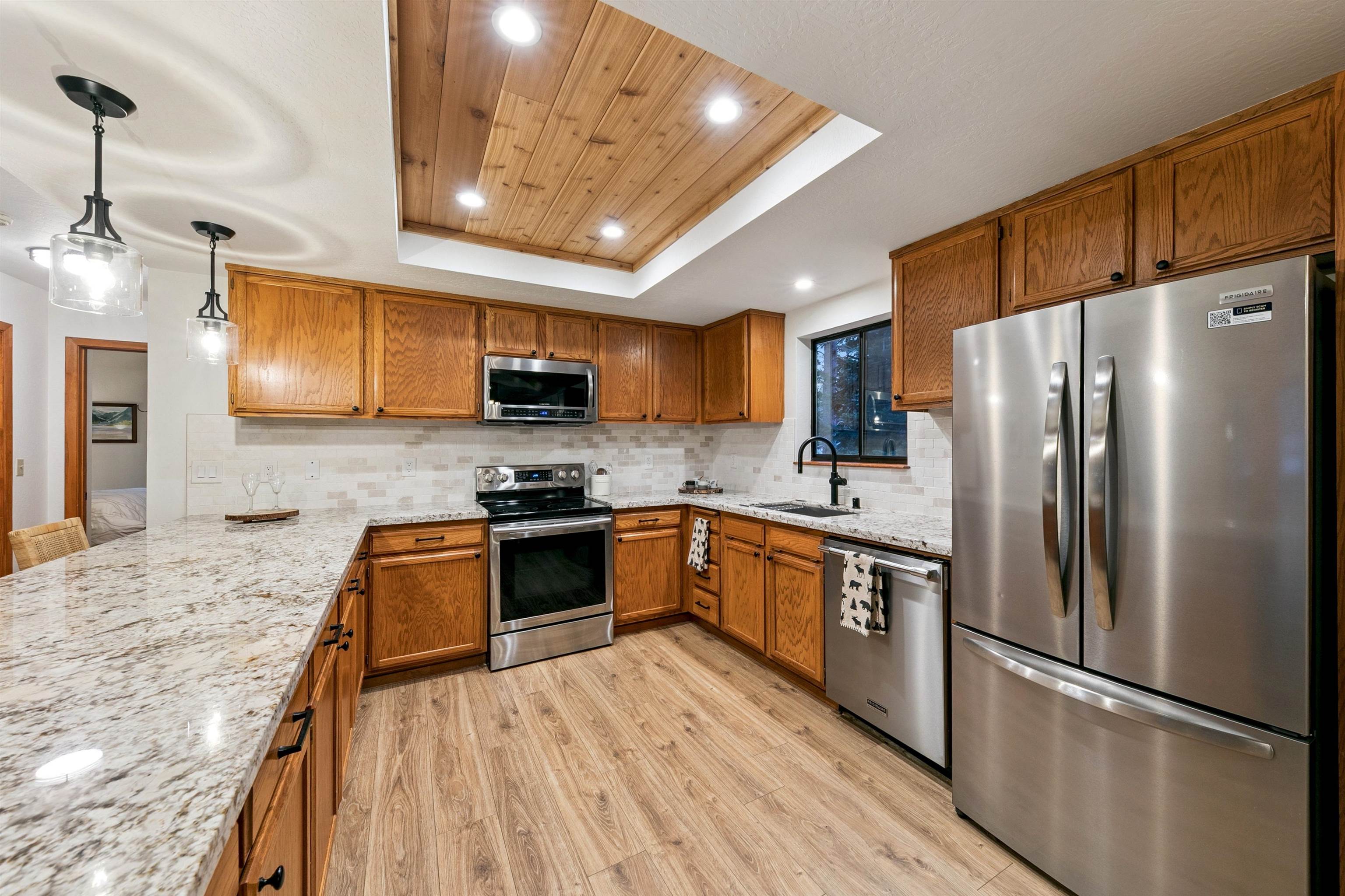 12095 Oslo Drive Truckee, CA 96161 - Photo 9 of 28 a kitchen with stainless steel appliances granite countertop a refrigerator a stove top oven a sink and dishwasher