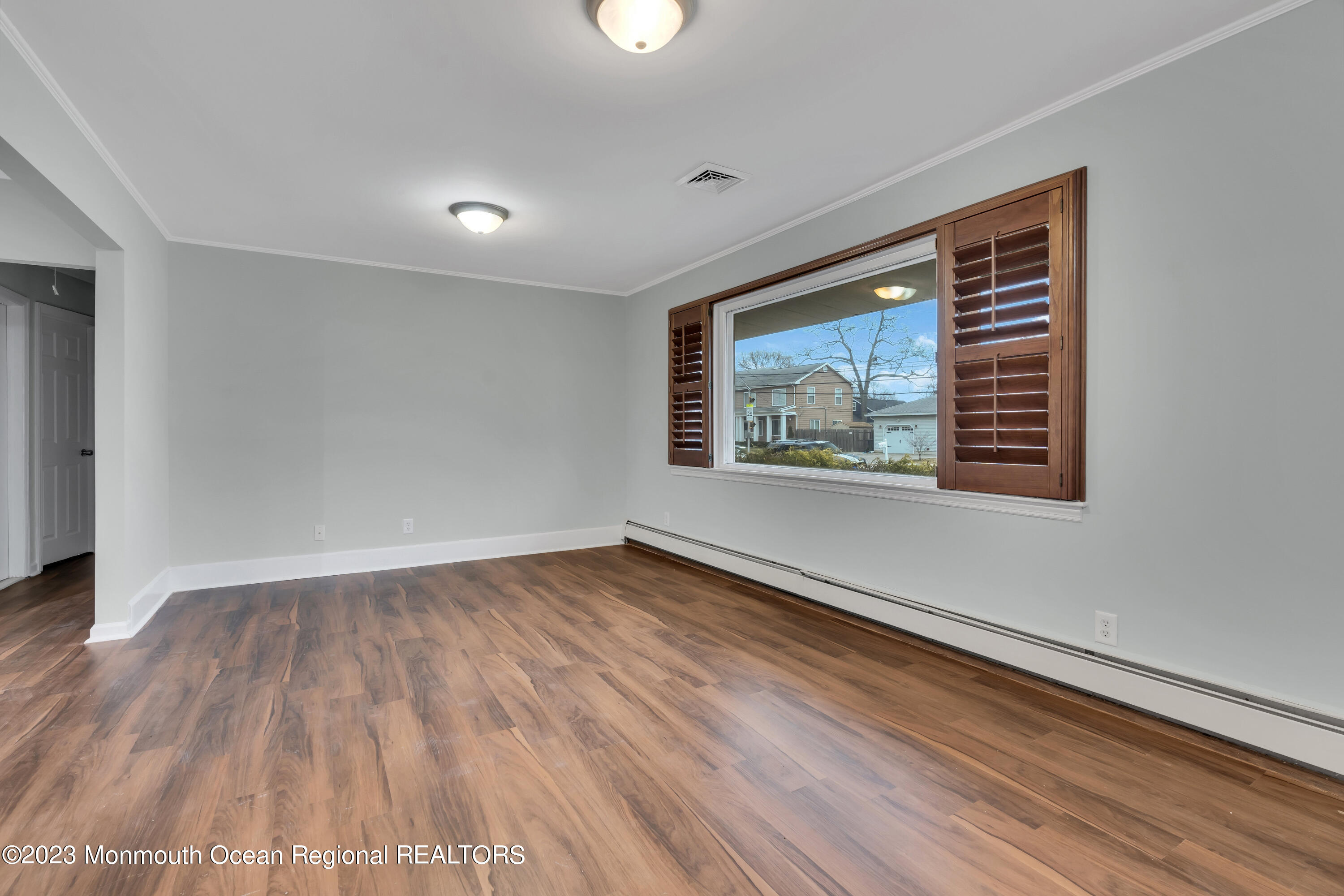 1007 Beaver Dam Road Point Pleasant, NJ 08742 - Photo 9 of 45 a view of an empty room with wooden floor and a window