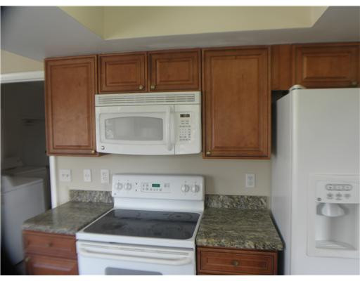 22747 Southwest 55th Way Boca Raton, FL 33433 - Photo 3 of 15 a kitchen with stainless steel appliances granite countertop a refrigerator and a stove top oven