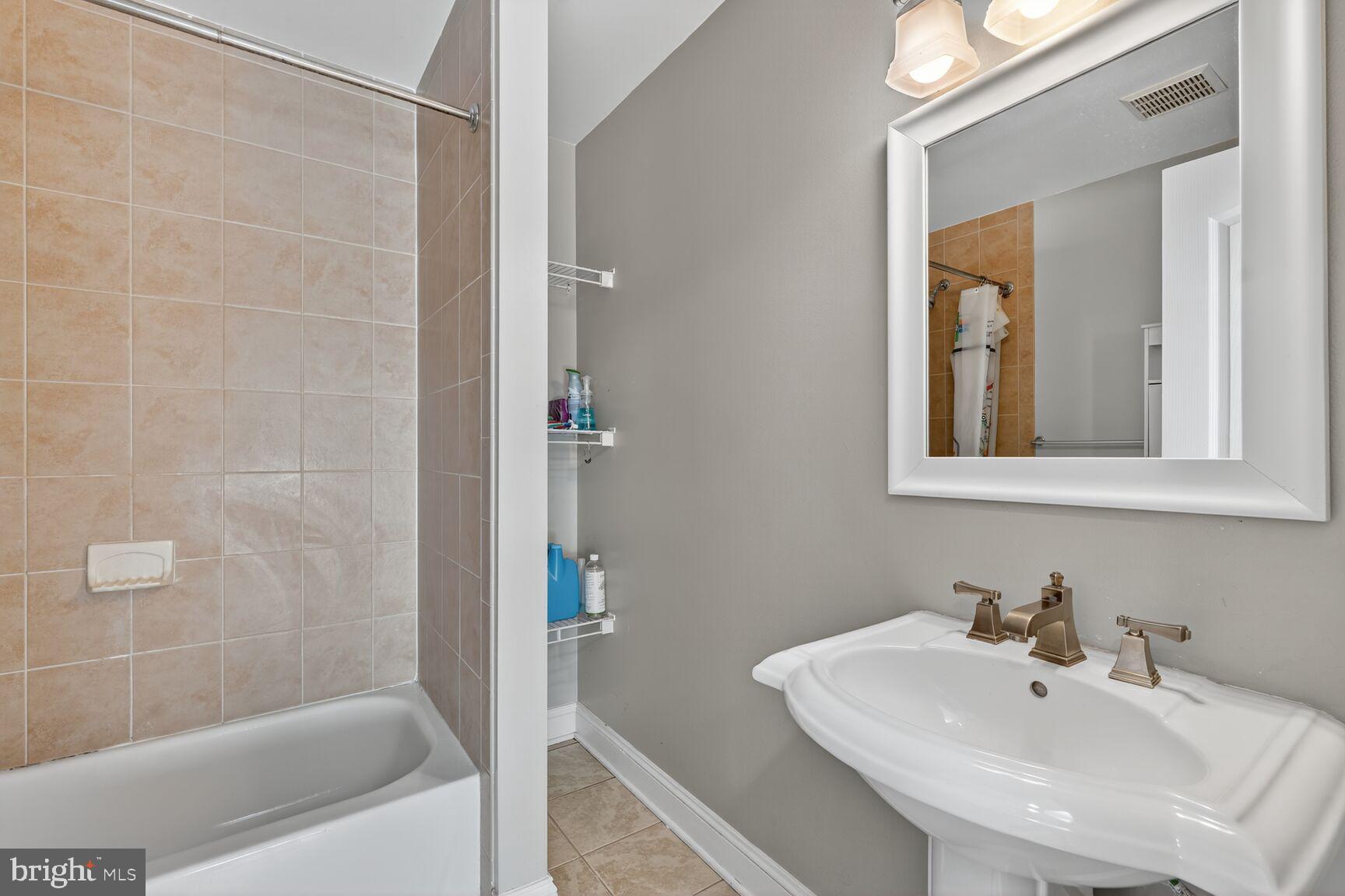 1730 1st Street Northwest, Unit 2 Washington, DC 20001 - Photo 17 of 27 a bathroom with a sink a shower and a mirror